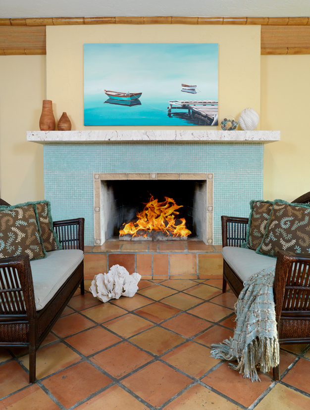 A breezy ocean view home with beach glass tile and coral rock Fireplace mantel