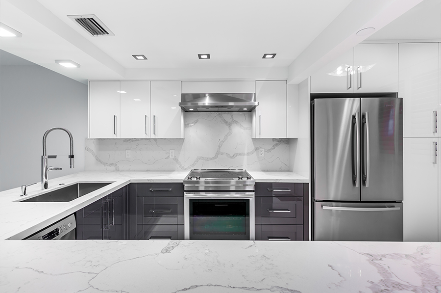 Slick and clean Kitchen design with Calacatta quartz counter top and backsplash.
